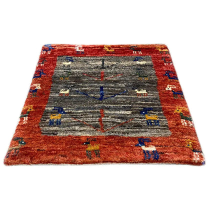 Gabbeh rug, square, reddish-brown border with gray center and colorful ornaments