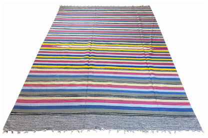Kelim dhurrie rug with a striped design in blue, pink, yellow, and gray, fringes