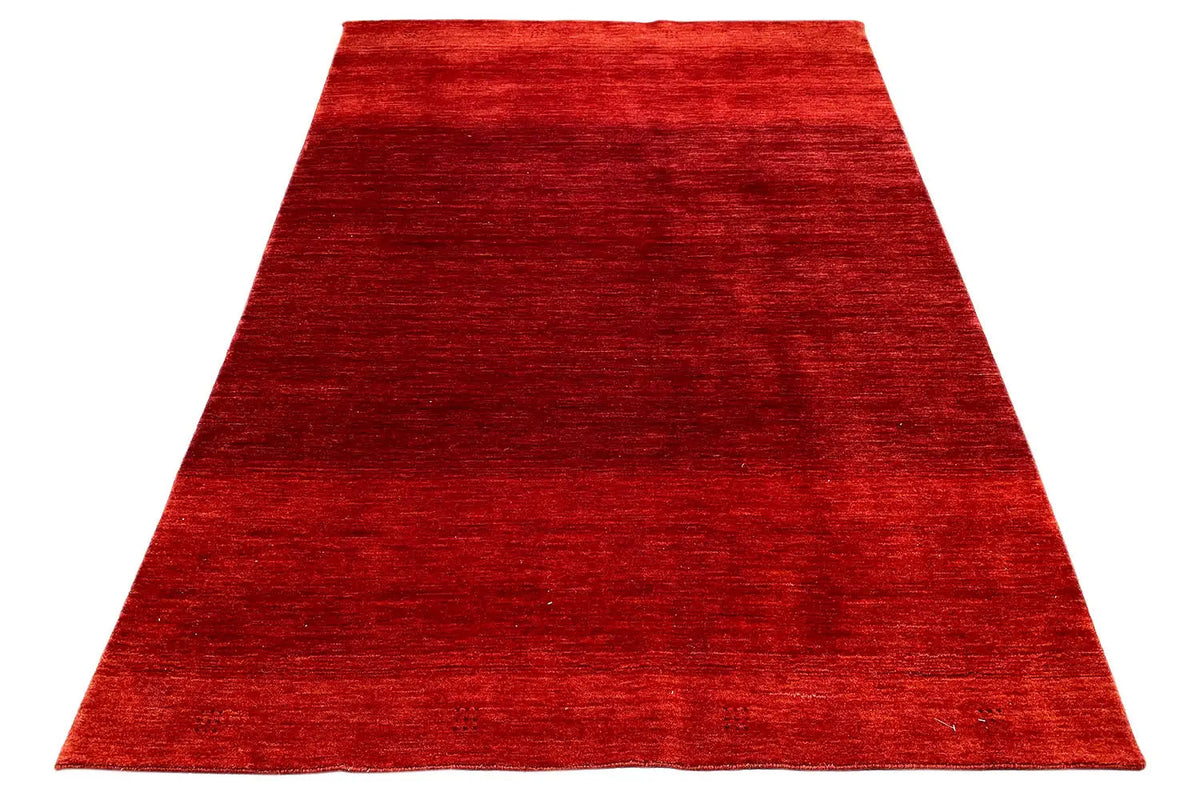 Red Gabbeh rug, triangular view laid flat with a subtle pile texture