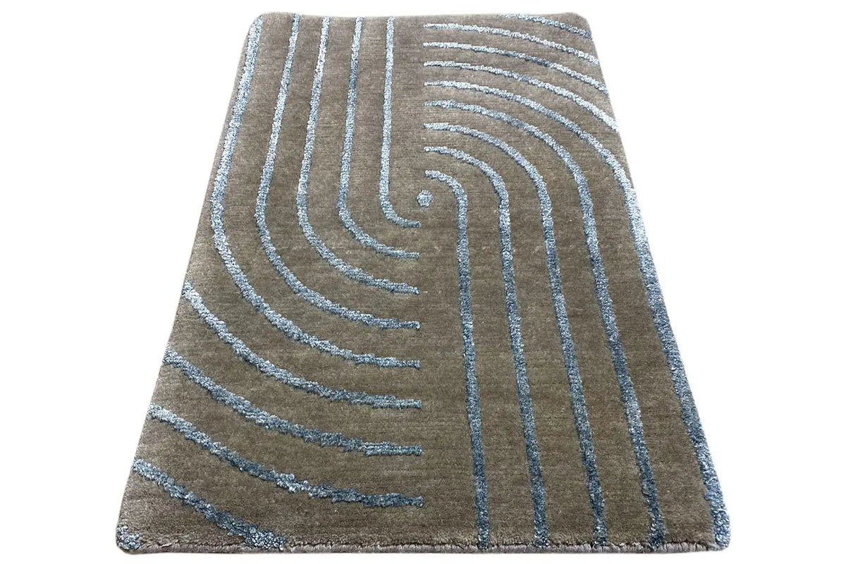 Designer rug with turquoise-blue swirling lines, spread out diagonally