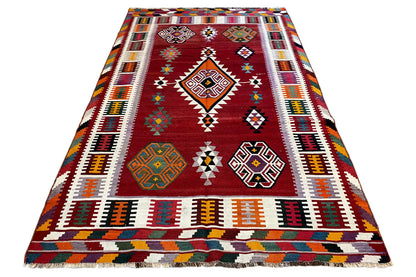 Kilim Qashqai rug, reddish brown with a central diamond motif and multicolored stripes