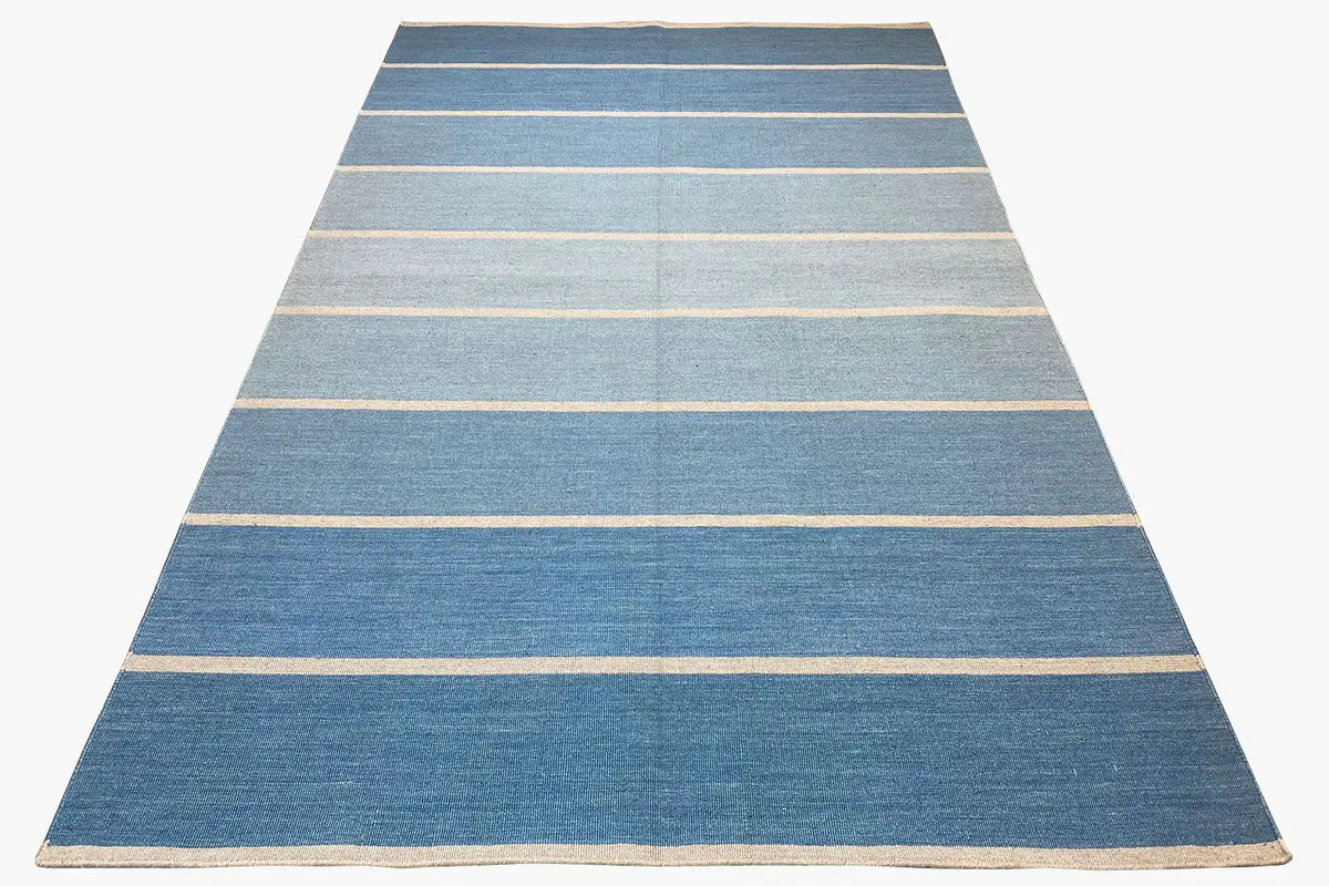 Kelim rug with a light blue background and beige horizontal stripes