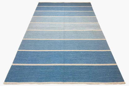 Kelim rug with a light blue background and beige horizontal stripes