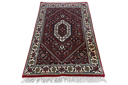 Bidjar rug 94x61 cm, rotated: red medallion, dark background, fringes