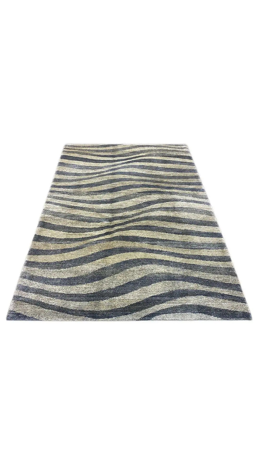 Gabbeh rug laid flat: zebra stripes in blue, gray, and beige