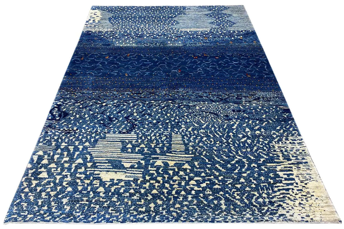 Triangularly arranged Gabbeh rug with a blue stripe layout and light textured pattern
