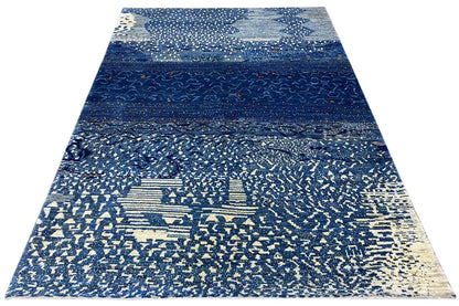 Triangularly arranged Gabbeh rug with a blue stripe layout and light textured pattern