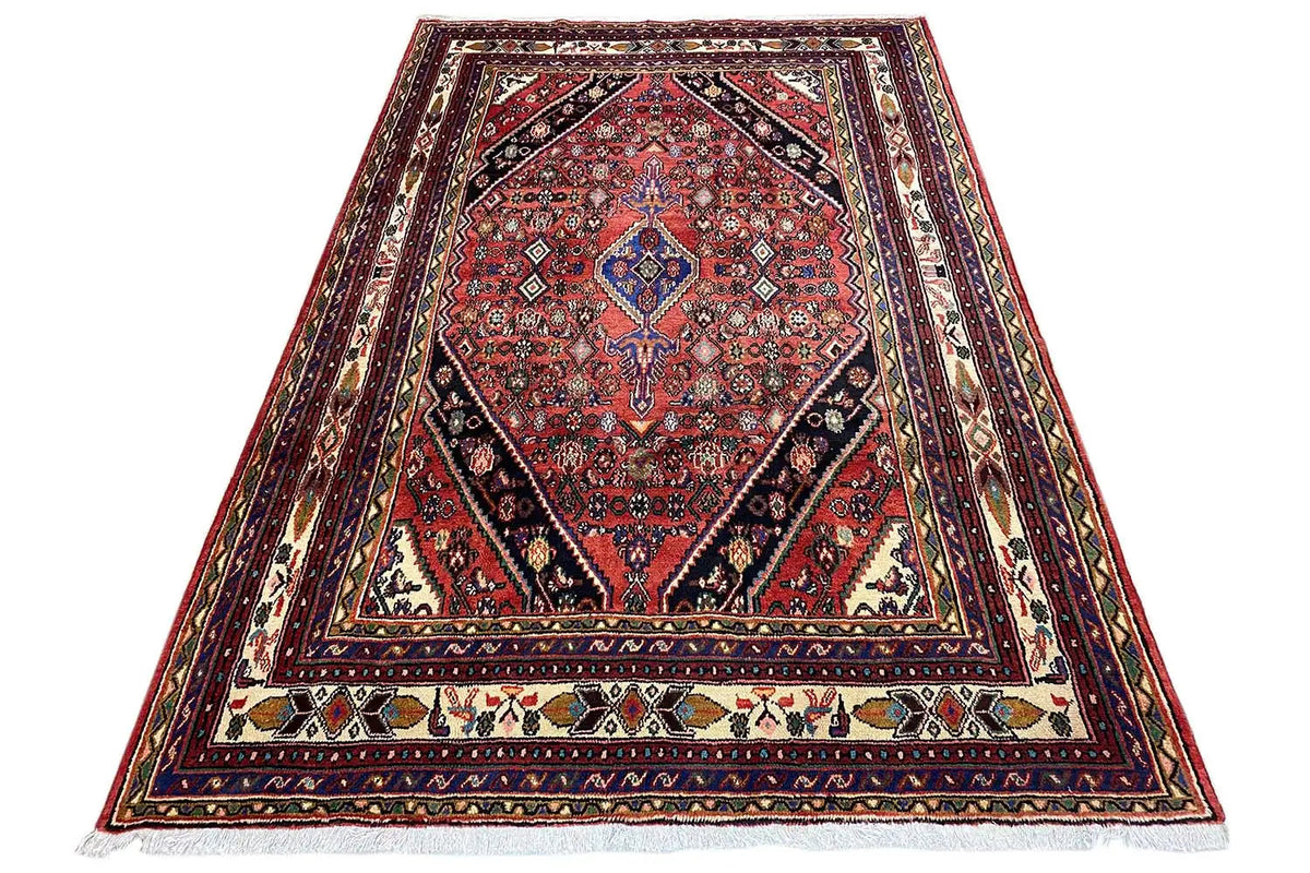 Triangular Oriental rug with a red medallion and multicolored ornaments