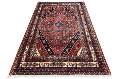 Triangular Oriental rug with a red medallion and multicolored ornaments