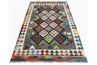 Kilim rug (160x101 cm) photographed diagonally, with a central diamond panel and border ornaments