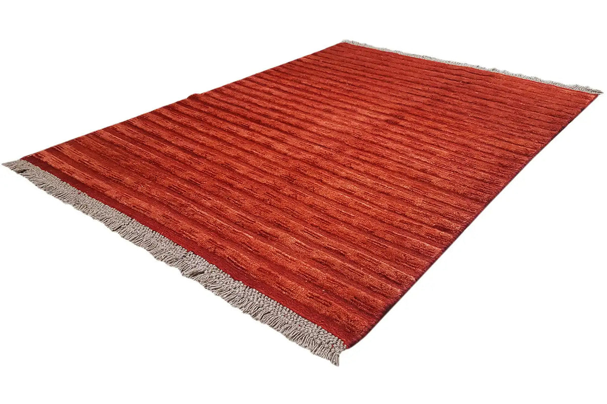 Reddish-brown Gabbeh rug, diagonal view with fringes on all edges