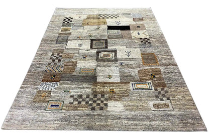 Gabbeh rug laid out flat: light gray design with patchwork squares and small ornaments