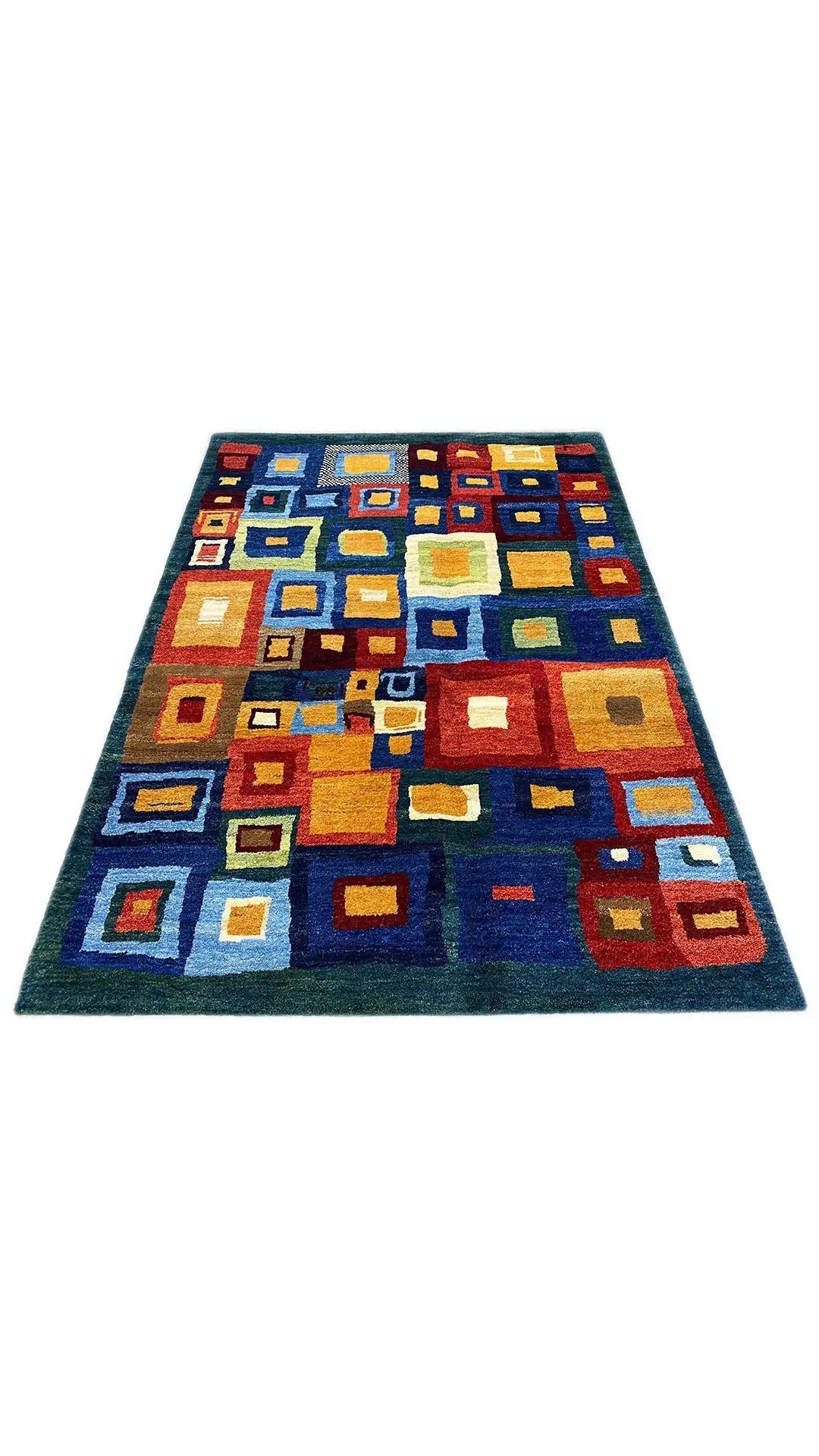 Gabbeh rug with a square patchwork pattern in blue, orange, yellow, and white.