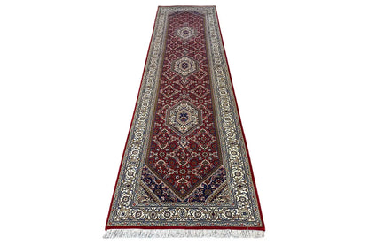 Bidjar runner in red tones with a fine dark blue pattern and beige fringes