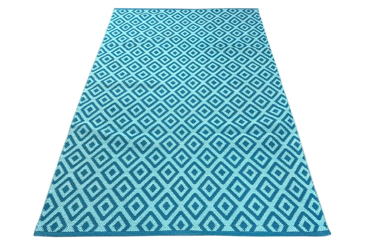 Blue kilim runner with a geometric diamond lattice pattern in light blue