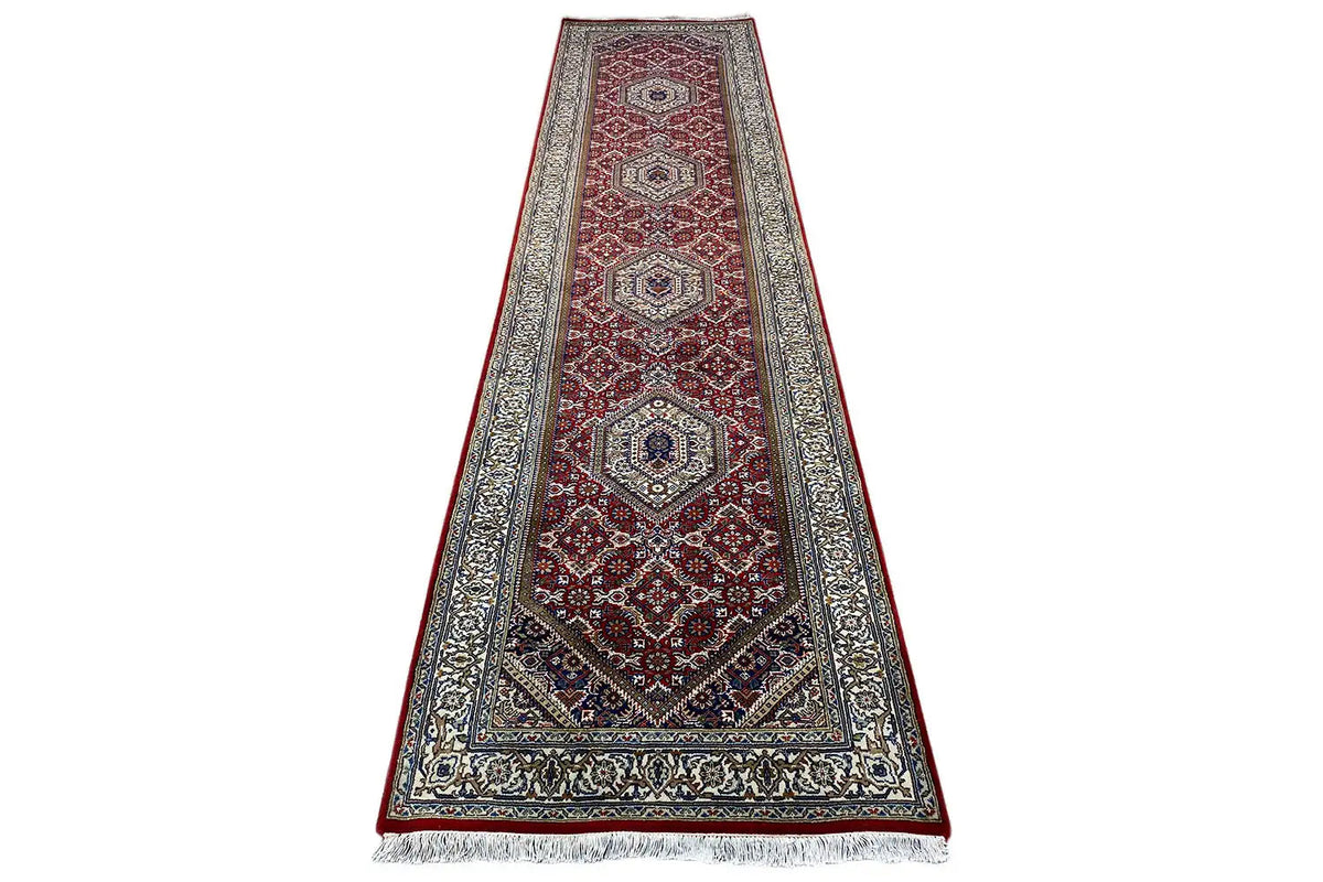 Bidjar runner in landscape format, red and blue medallion pattern with a wide border