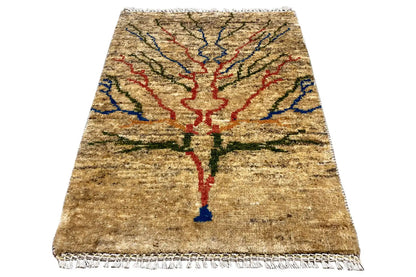 Beige rug with a central red-blue-green pattern and fringes around the edges