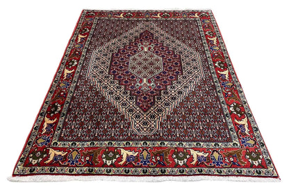 Rug with a rectangular pattern and decorative border, dark red with blue-green accents