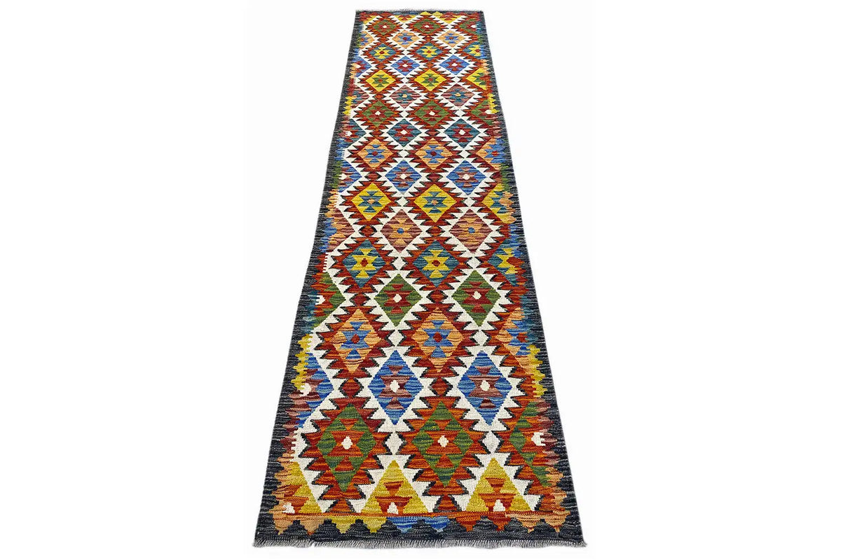Rectangular kilim runner with a dark-bordered geometric design in many colors