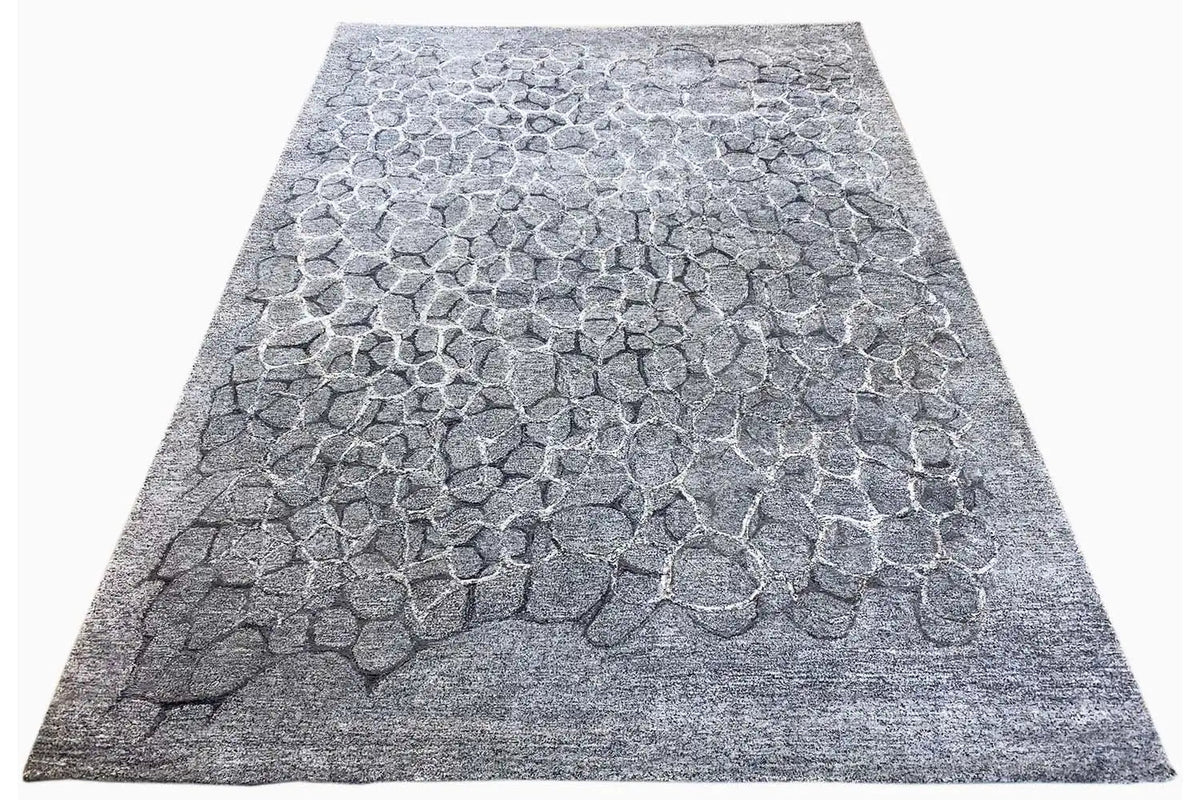 Hand-tufted gray rug with a 3D relief pattern of irregular stones