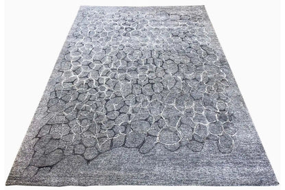 Hand-tufted gray rug with a 3D relief pattern of irregular stones