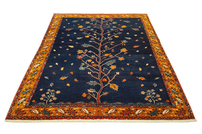 Oriental rug with a blue background, a golden-brown border, and a central tree motif