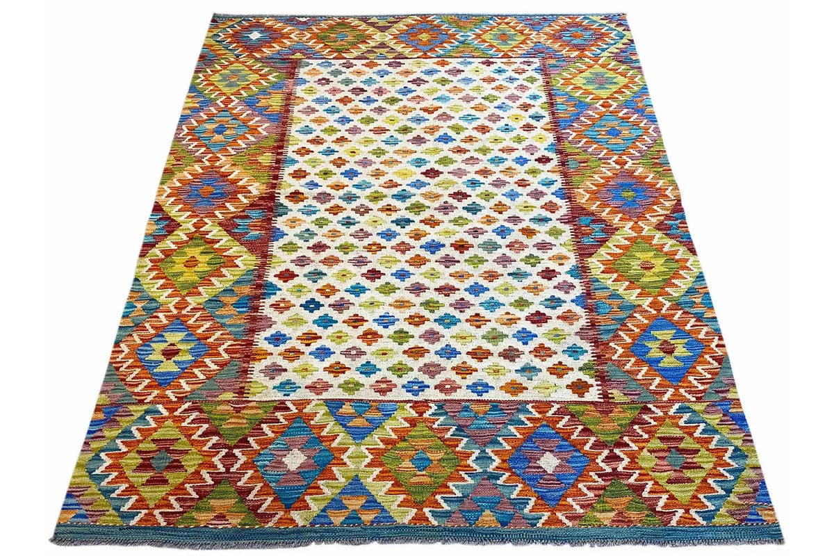 Afghan kilim rug in three-quarter view with multicolored decorative borders and diamonds