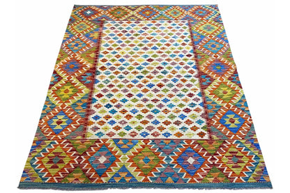 Afghan kilim rug in three-quarter view with multicolored decorative borders and diamonds