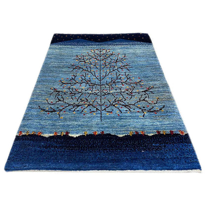 Gabbeh rug, mottled blue with gray tree vines and colorful dots, rectangular