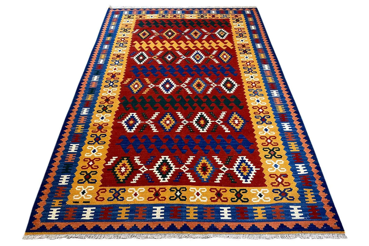 Kilim rug with a red center, blue border, and short fringes