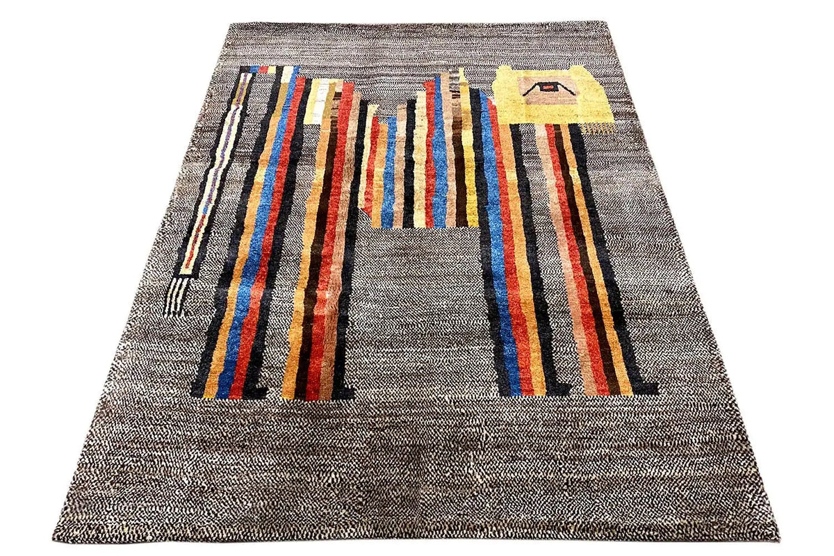 Low-pile rug, photographed from a trapezoidal angle: gray background with broad multicolored stripes.