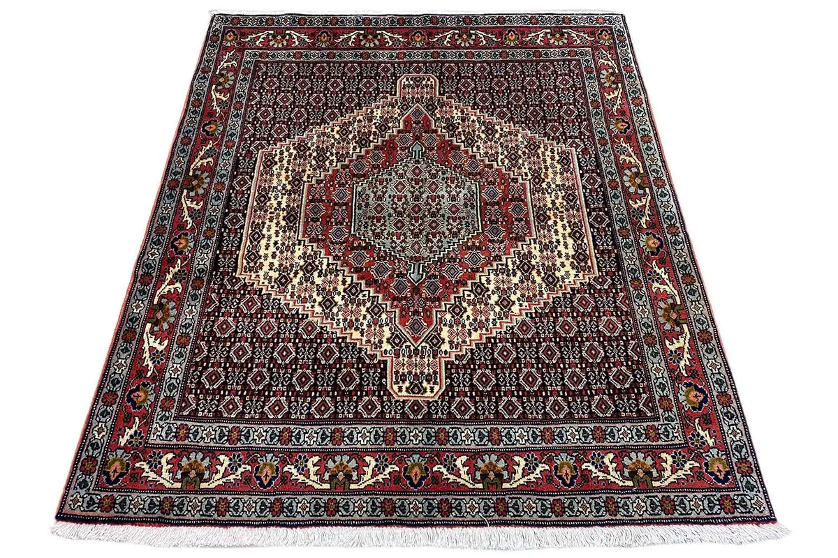 Hamadan rug in trapezoidal view with a medallion pattern in red, blue, and beige