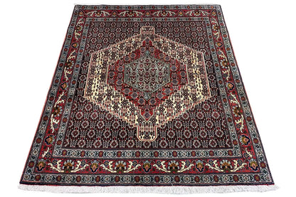 Hamadan rug in trapezoidal view with a medallion pattern in red, blue, and beige