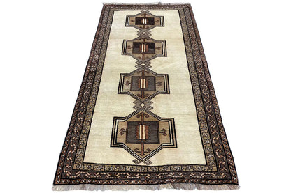 Oriental rug with a beige background, brown medallion pattern, and wide border.
