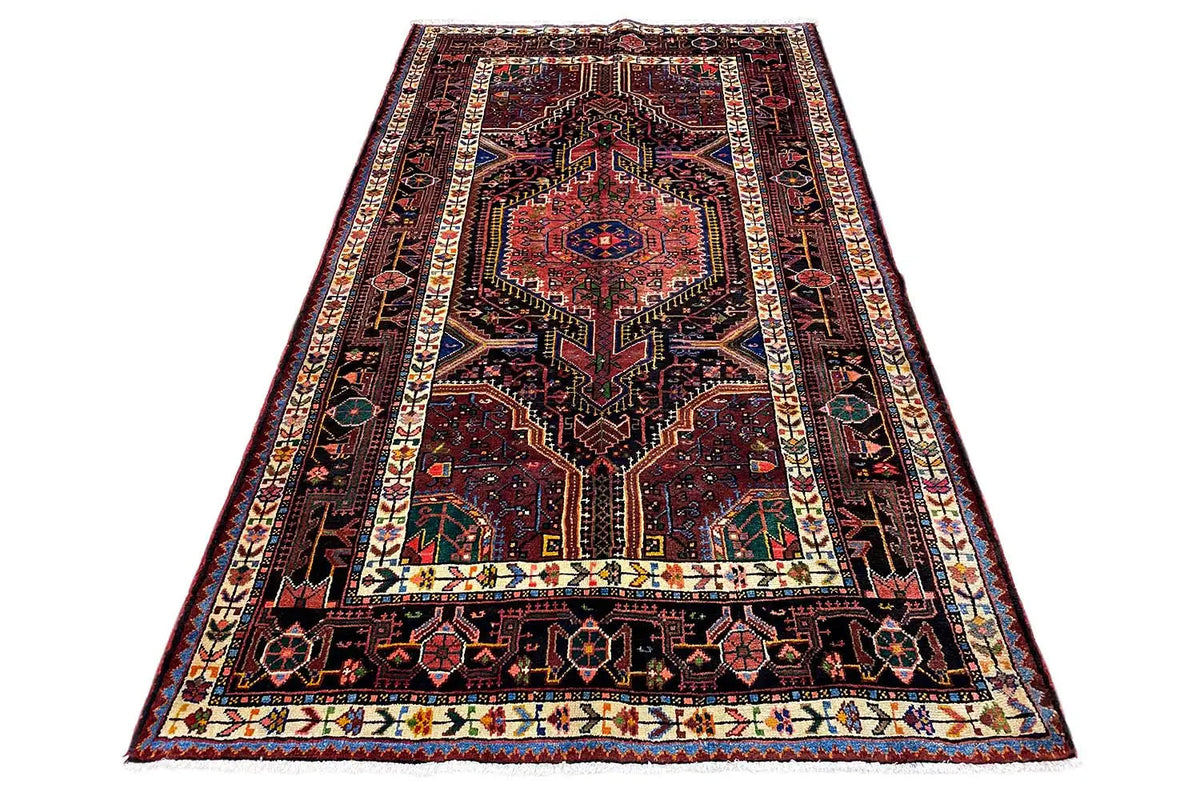 Carpet with a red central medallion, dark background, and multicolored border