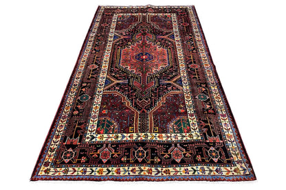 Carpet with a red central medallion, dark background, and multicolored border