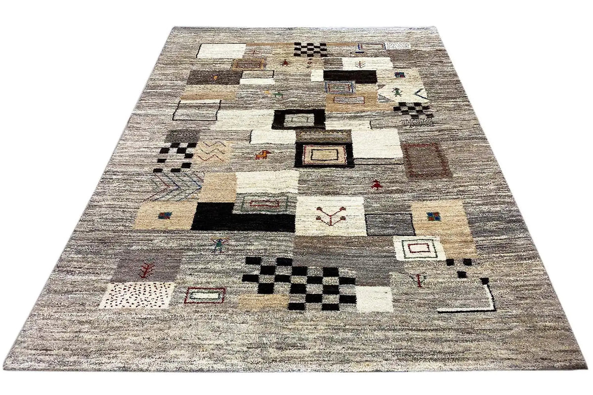 Rug surface with geometric motifs and patchwork shapes in beige, gray, and black