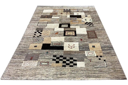 Rug surface with geometric motifs and patchwork shapes in beige, gray, and black