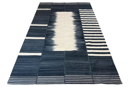 Modern kilim in a triangular design with striped borders in dark blue and white