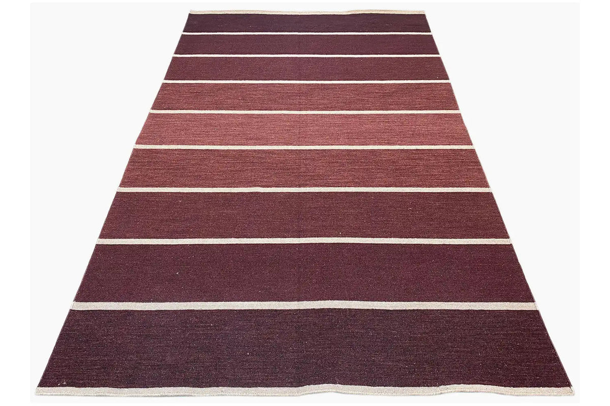Modern kilim with a striped pattern in burgundy and white lines, creating a triangular effect