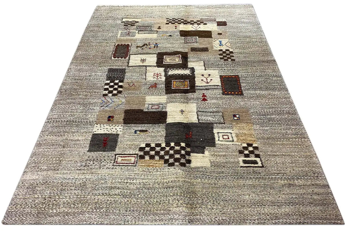 Gabbeh rug with a light gray base and patchwork squares in brown, black, and beige