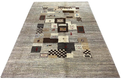 Gabbeh rug with a light gray base and patchwork squares in brown, black, and beige
