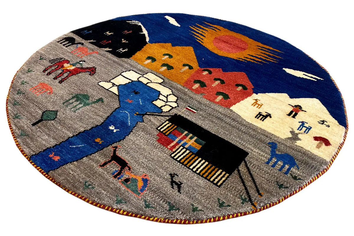 Round Gabbeh rug with a multicolored landscape motif and house and animal figures