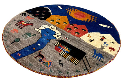 Round Gabbeh rug with a multicolored landscape motif and house and animal figures