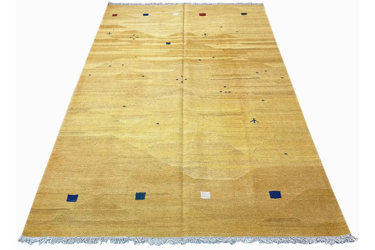 Ochre kilim rug with colorful small squares and wide fringes along the edge