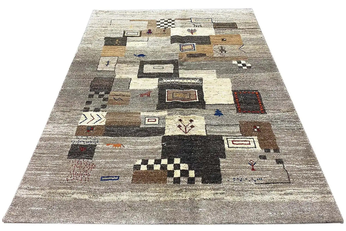 Gabbeh rug with a beige background and colorful patchwork elements, viewed from above.