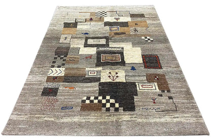 Gabbeh rug with a beige background and colorful patchwork elements, viewed from above.