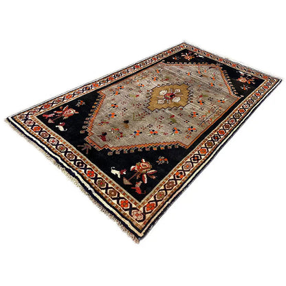 Rug with a black base, an oriental medallion, and decorative borders