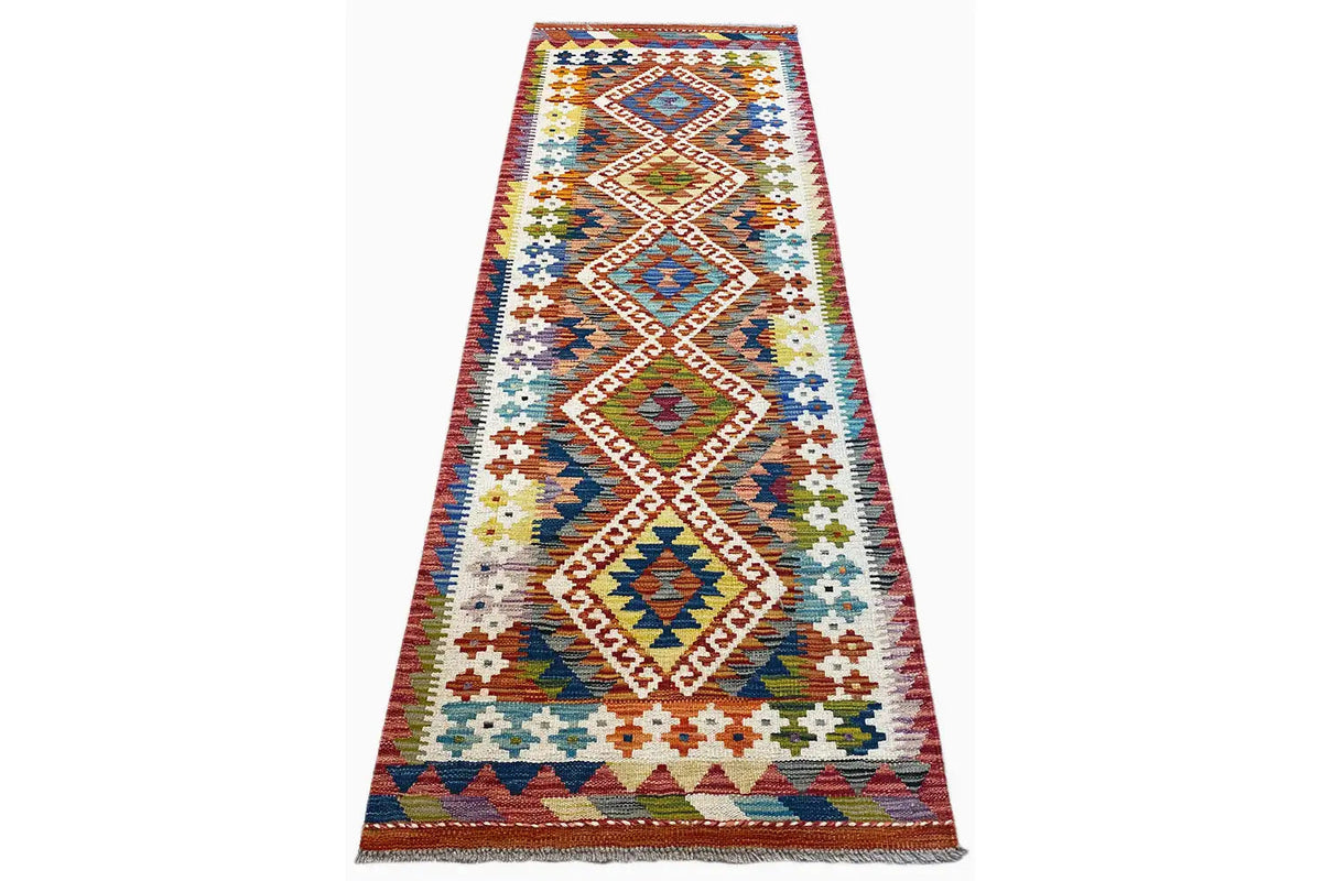 Kelim Afghan runner with diagonal diamond patterns in blue, red, green, and beige, approx. 192x64 cm