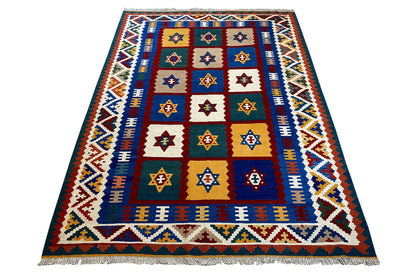 Qashqai kilim rug with a central diamond field, blue-and-white decorative border, and fringes
